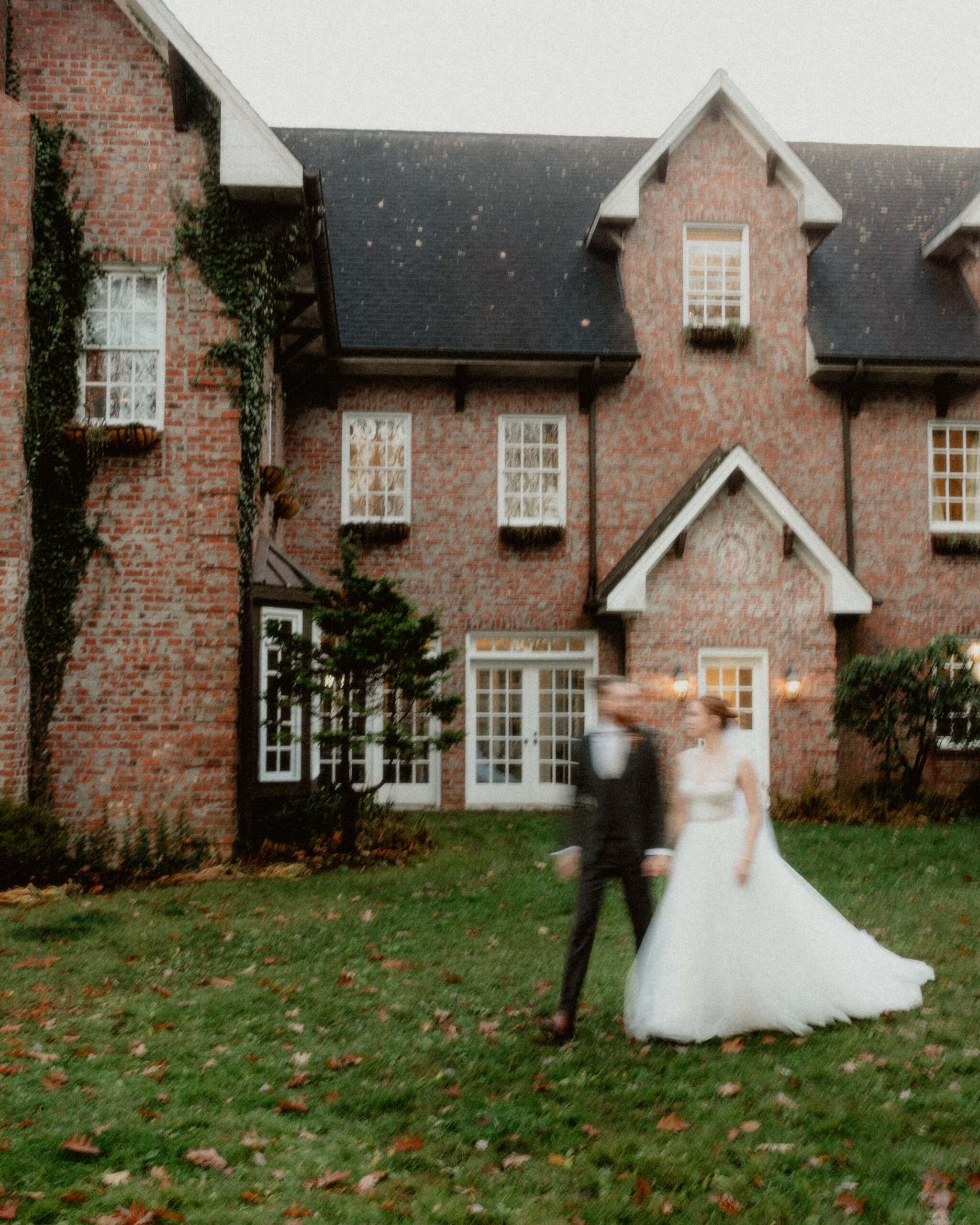 Newlywed wedding couple walk past the manor at Twickenham House and Hall Venue