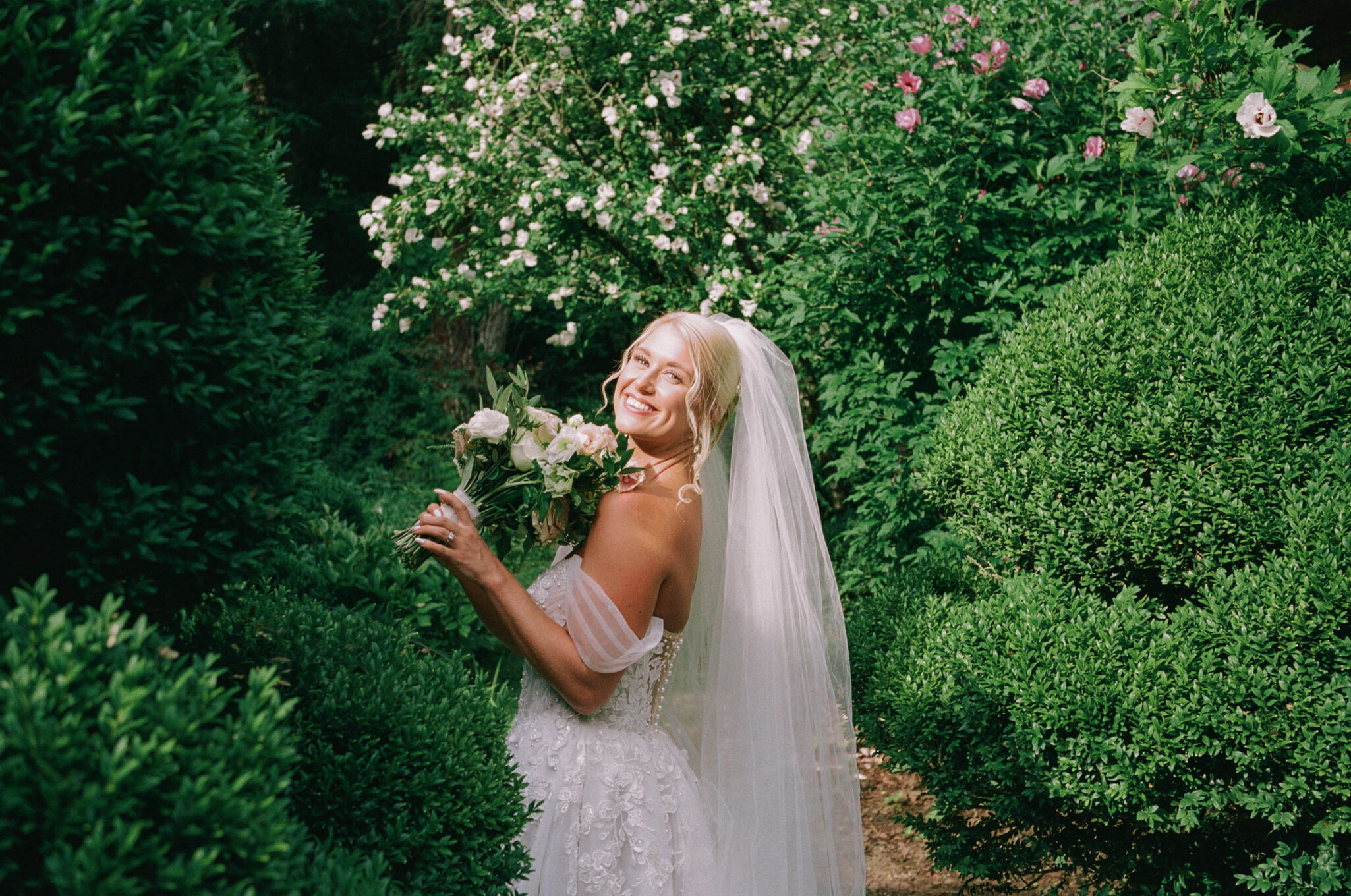 bride in the greenery on 35mm film photography of a wedding in asheville, nc