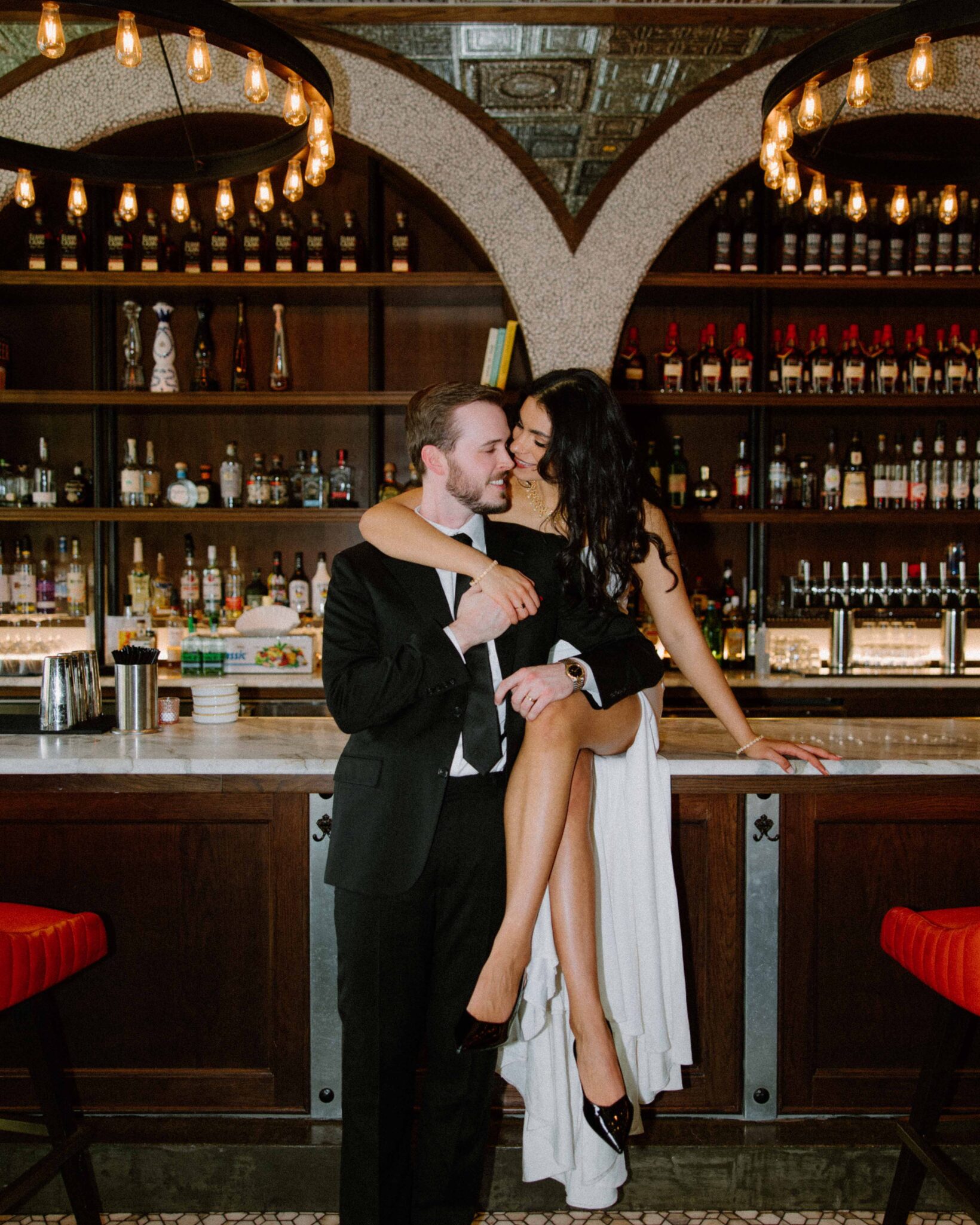 Bride and Groom in a bar in Asheville in Wedding Attire 