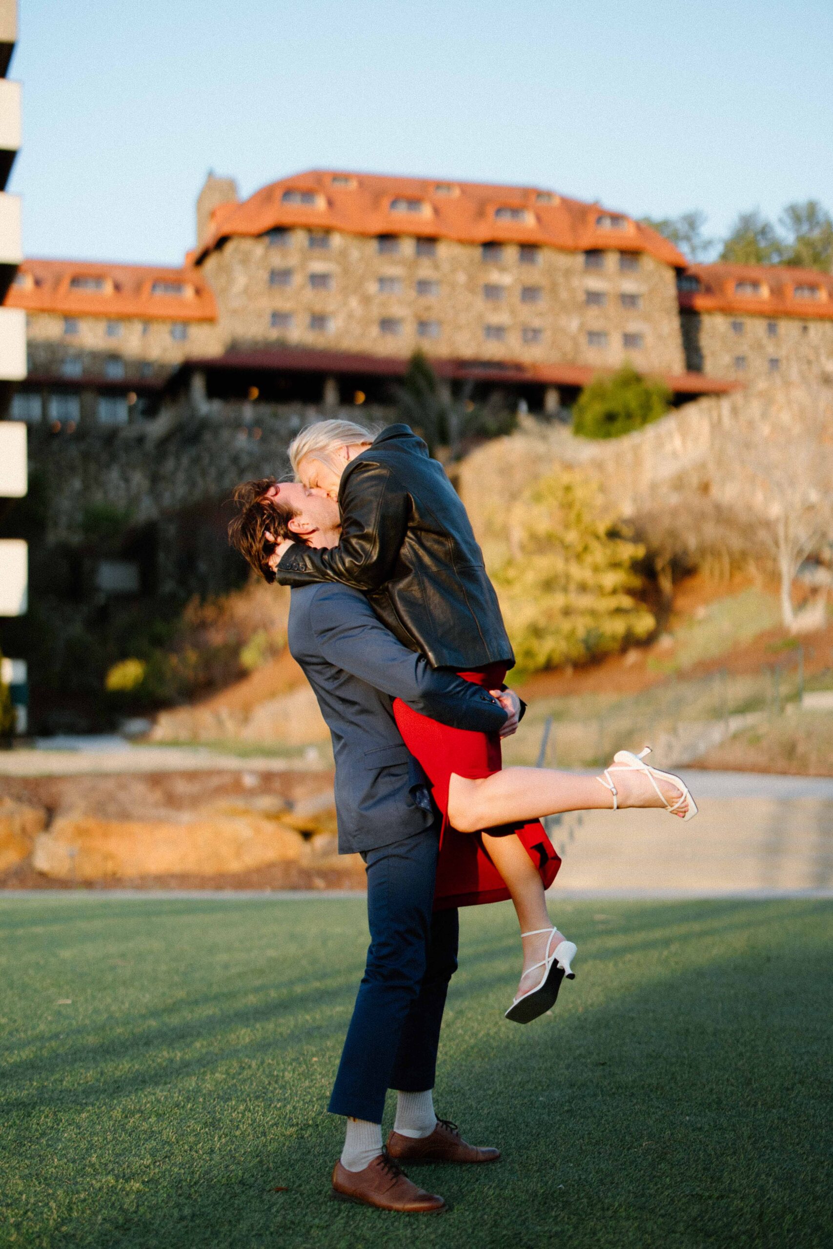 a couple at the Grove Park Inn spinning after a surprise proposal