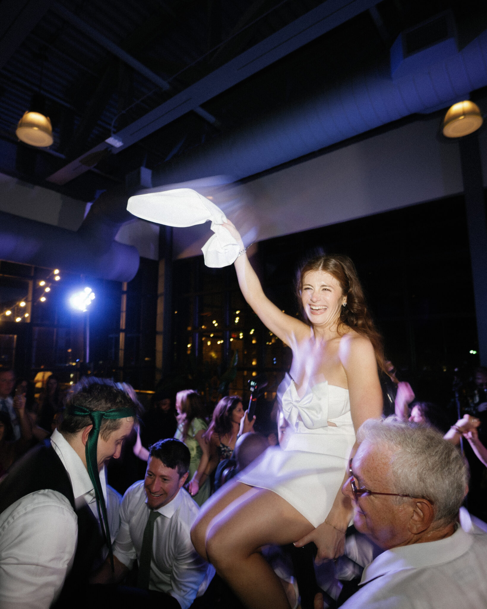 Bride and groom dancing during the hora chair lift