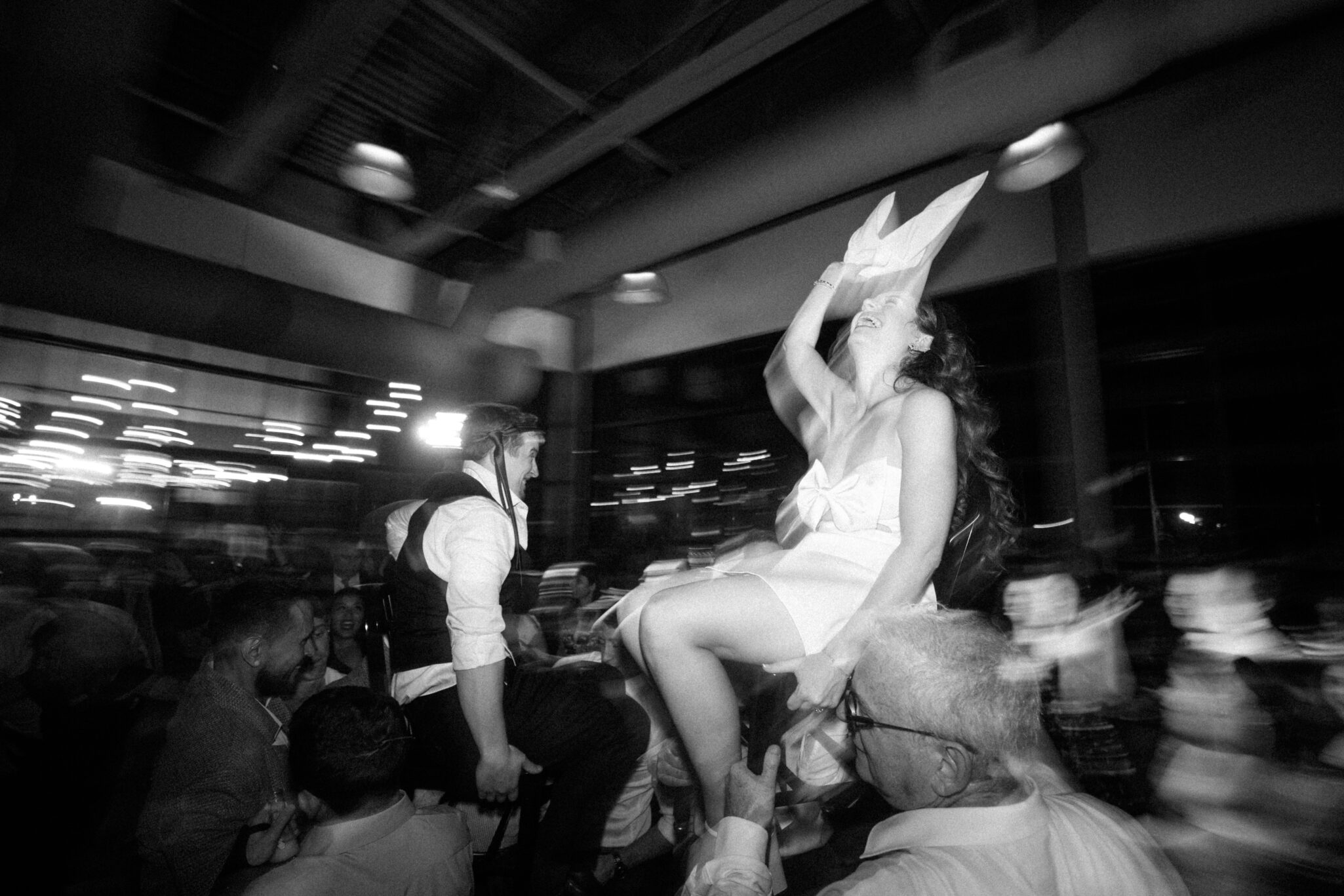 Bride and groom dancing during the hora chair lift