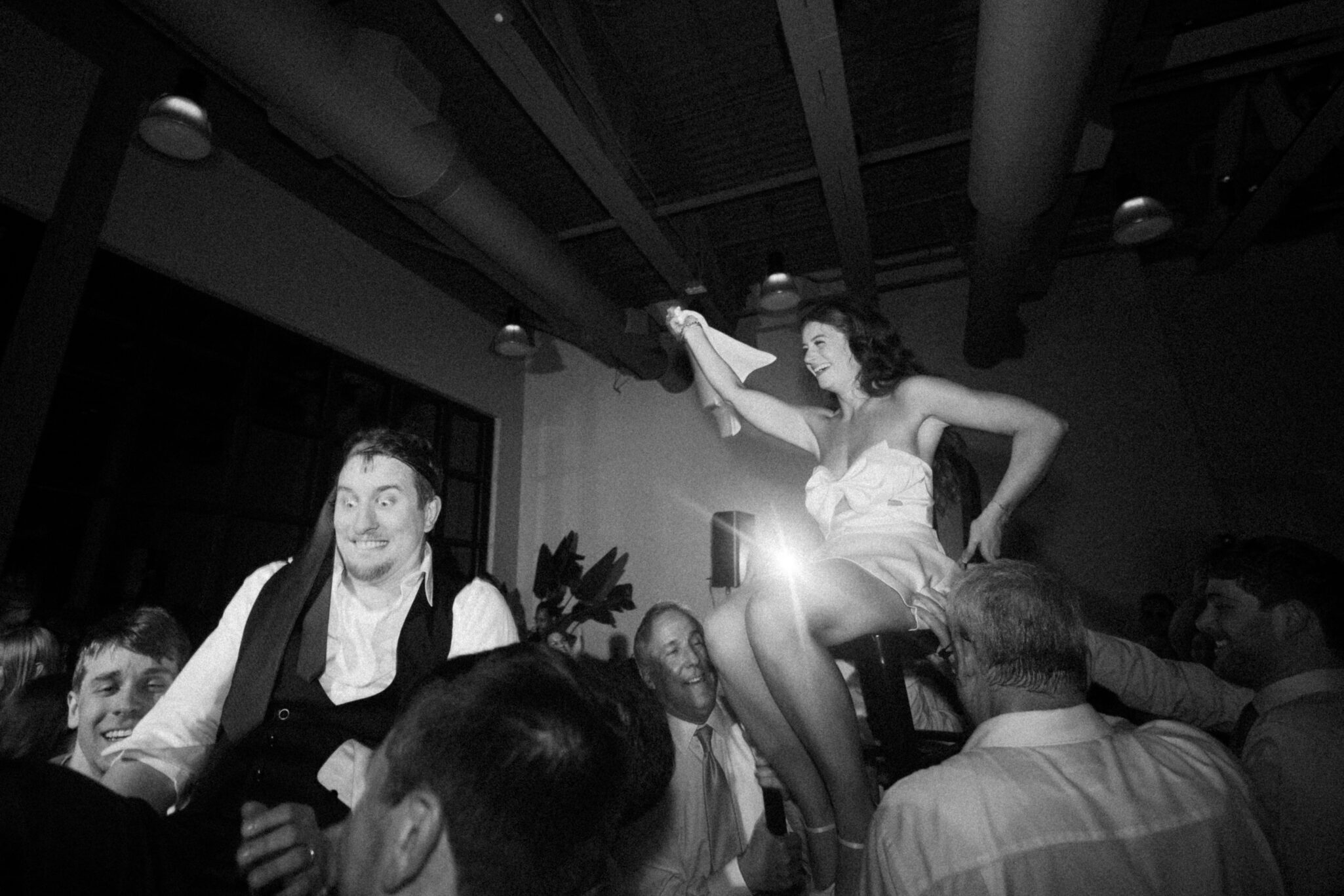 Bride and groom dancing during the hora chair lift