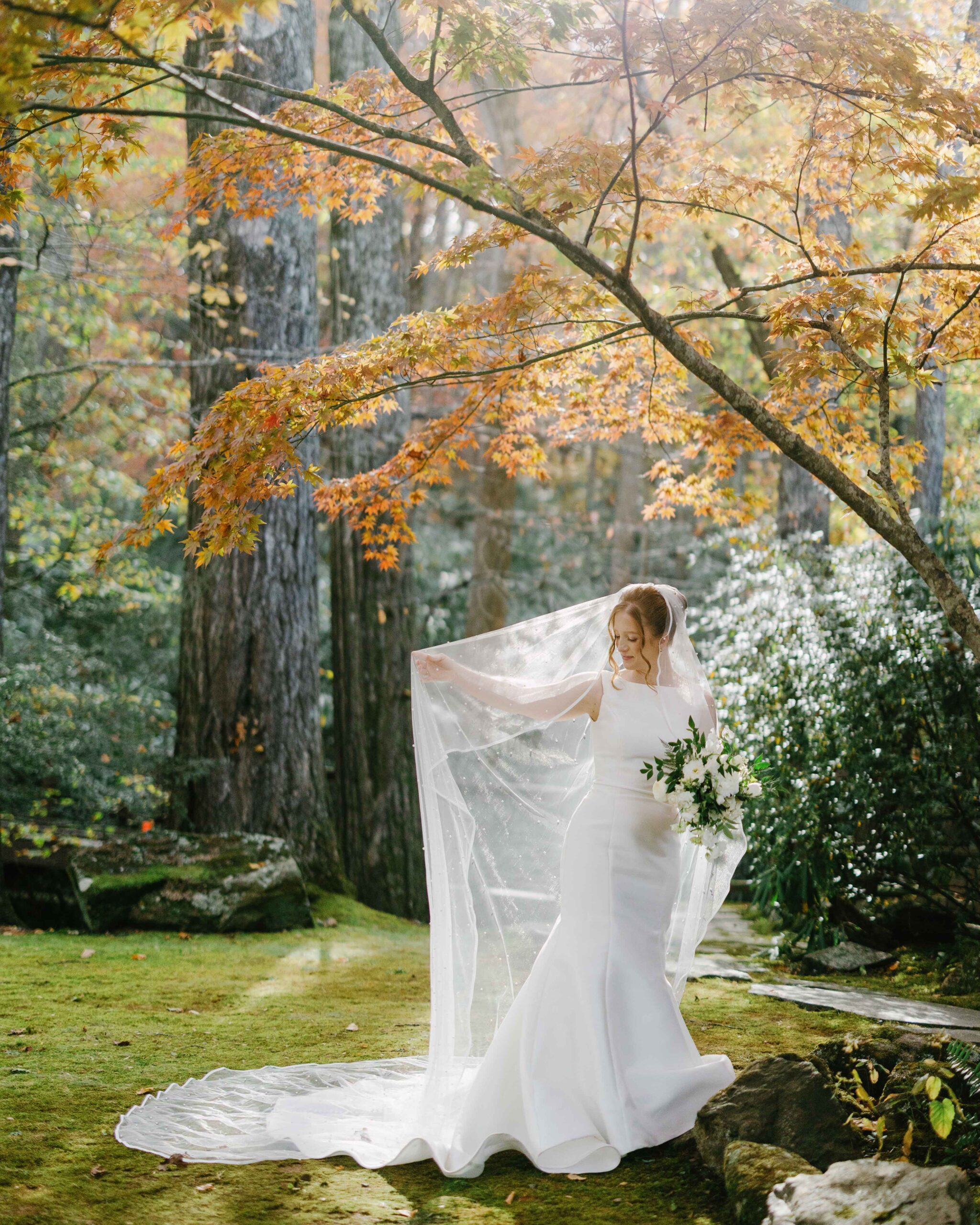 a bride in the sunlight on a fall wedding at lake eden retreat