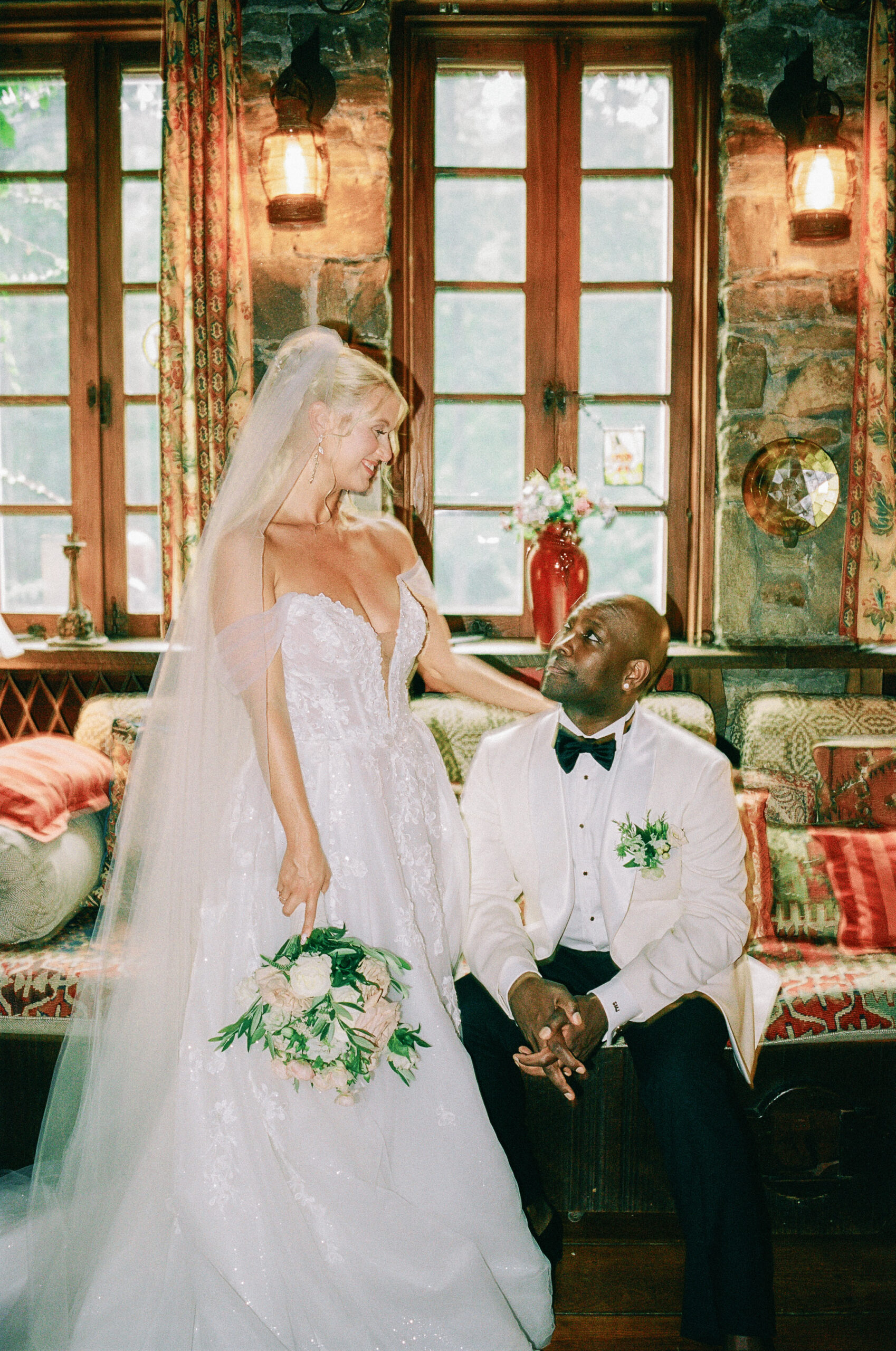 Bride and groom sitting together in an editorial film wedding portrait