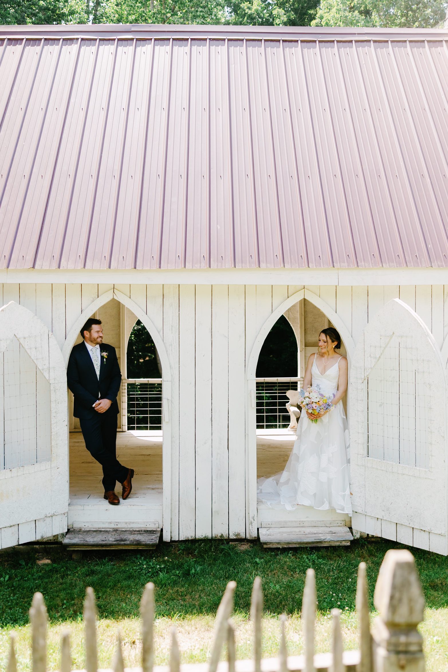 Bride and groom framed by white pointed doorways