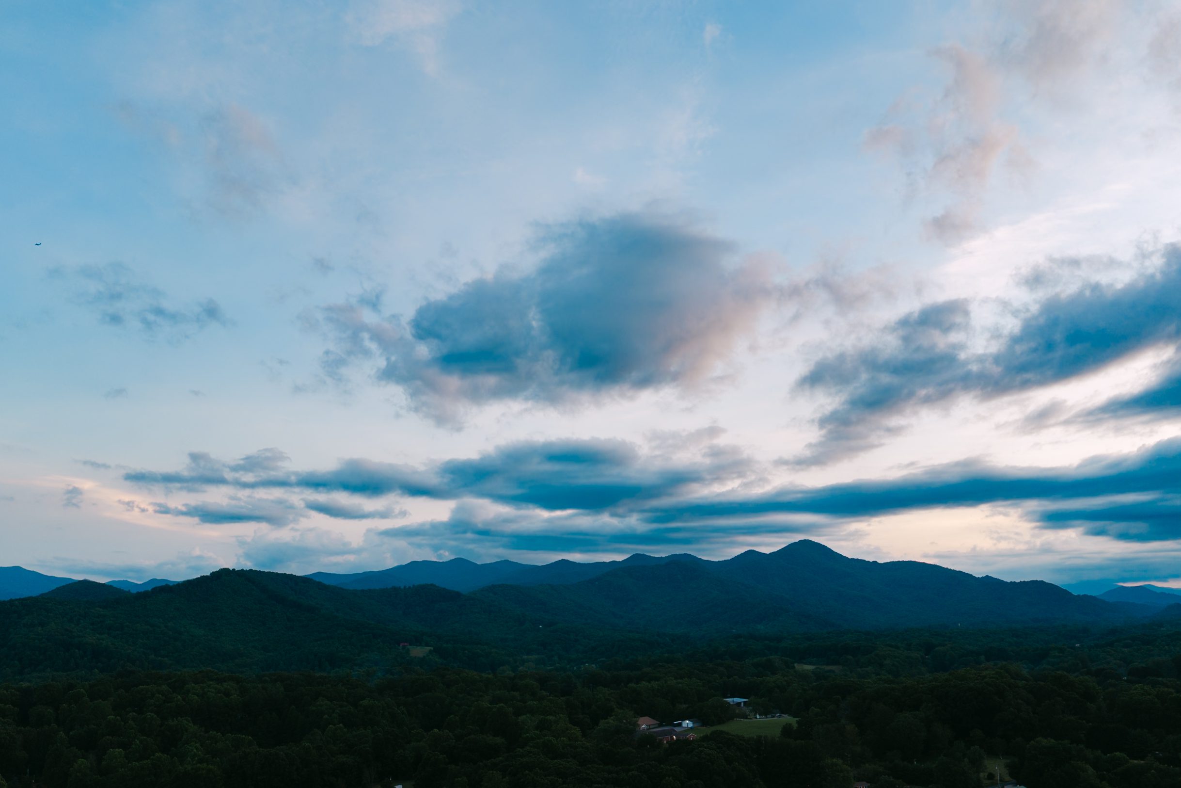 Mountain ridges beneath a cloudy evening sky