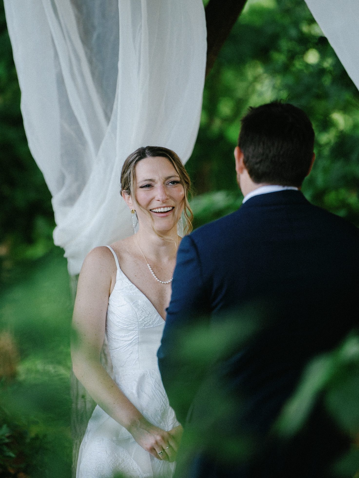 Bride smiling at the groom during the outdoor ceremony