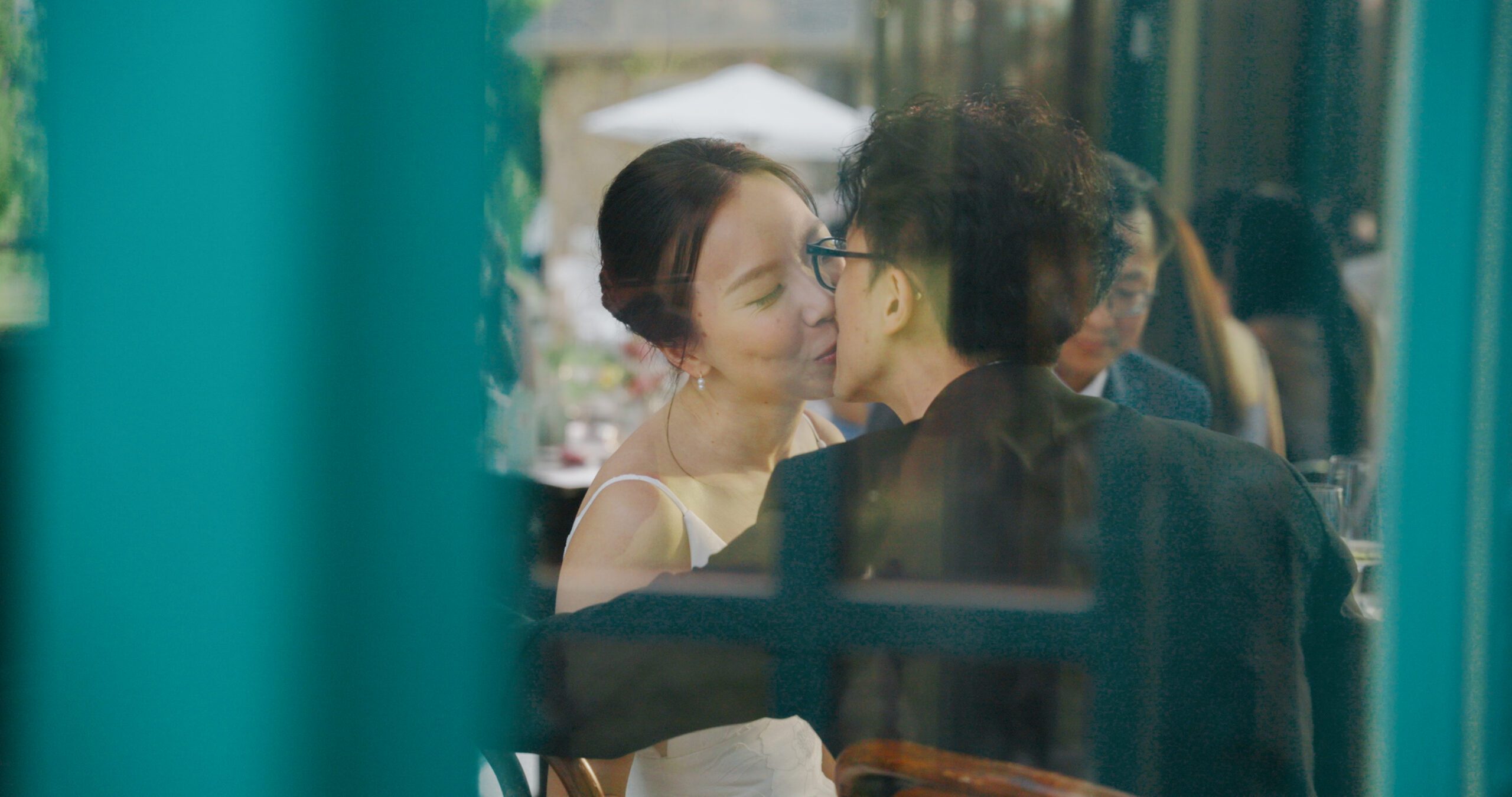 Christie and Hao share a kiss at their reception table in the Solarium.
