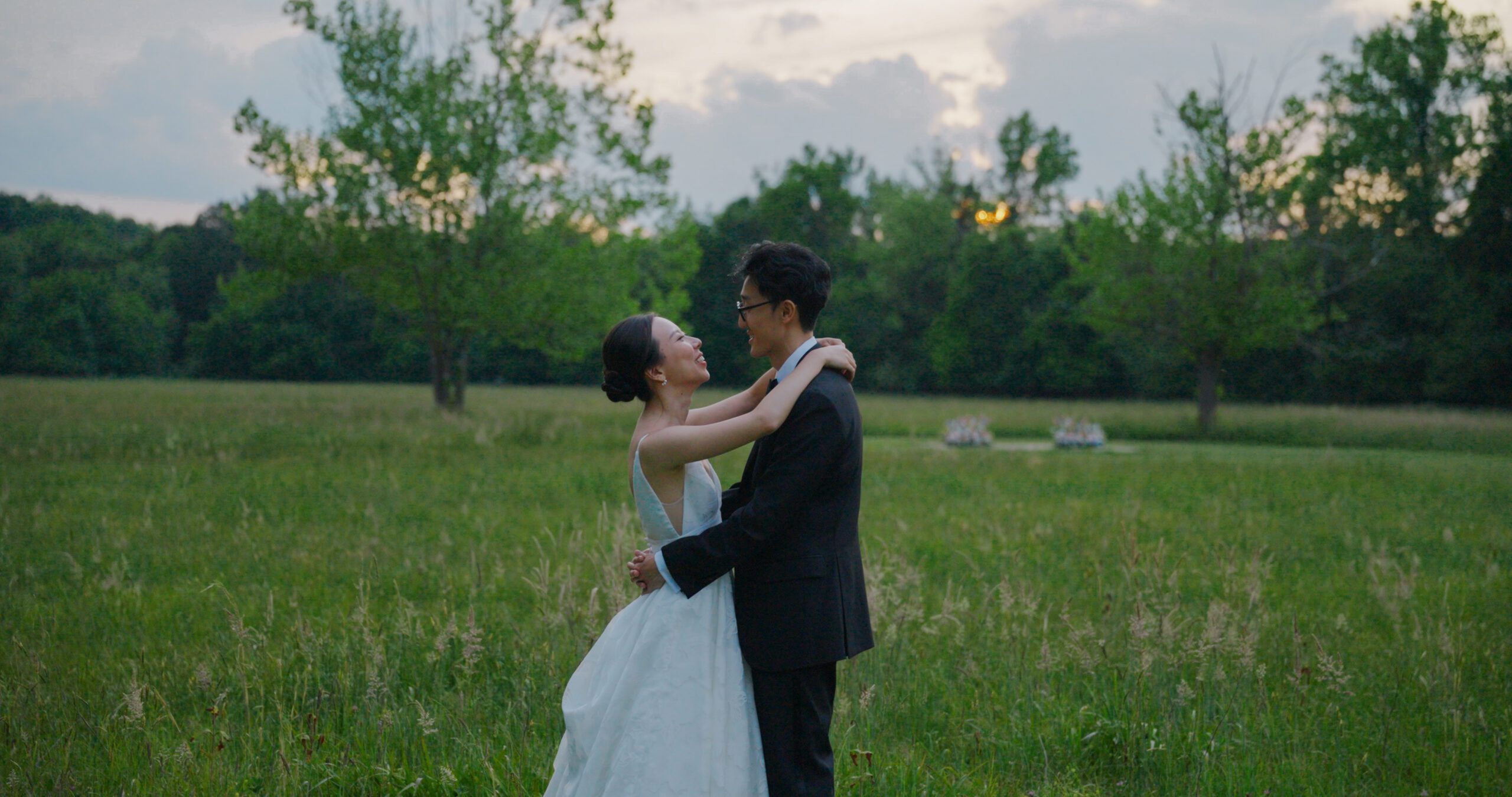 Christie and Hao dance together in the meadow at Haven Ridge in the evening light.