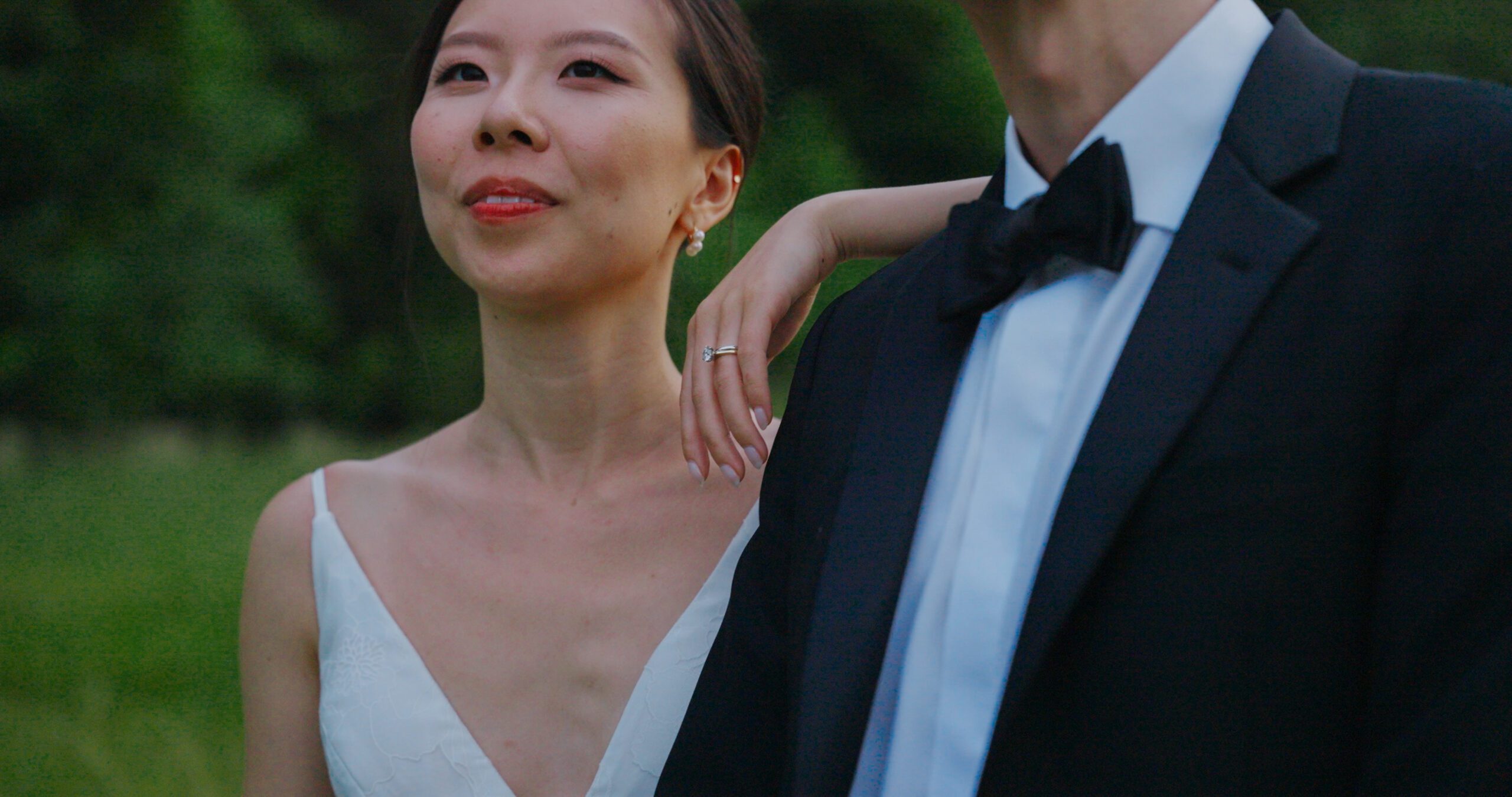 A close portrait of Christie standing beside Hao in the Haven Ridge meadow.