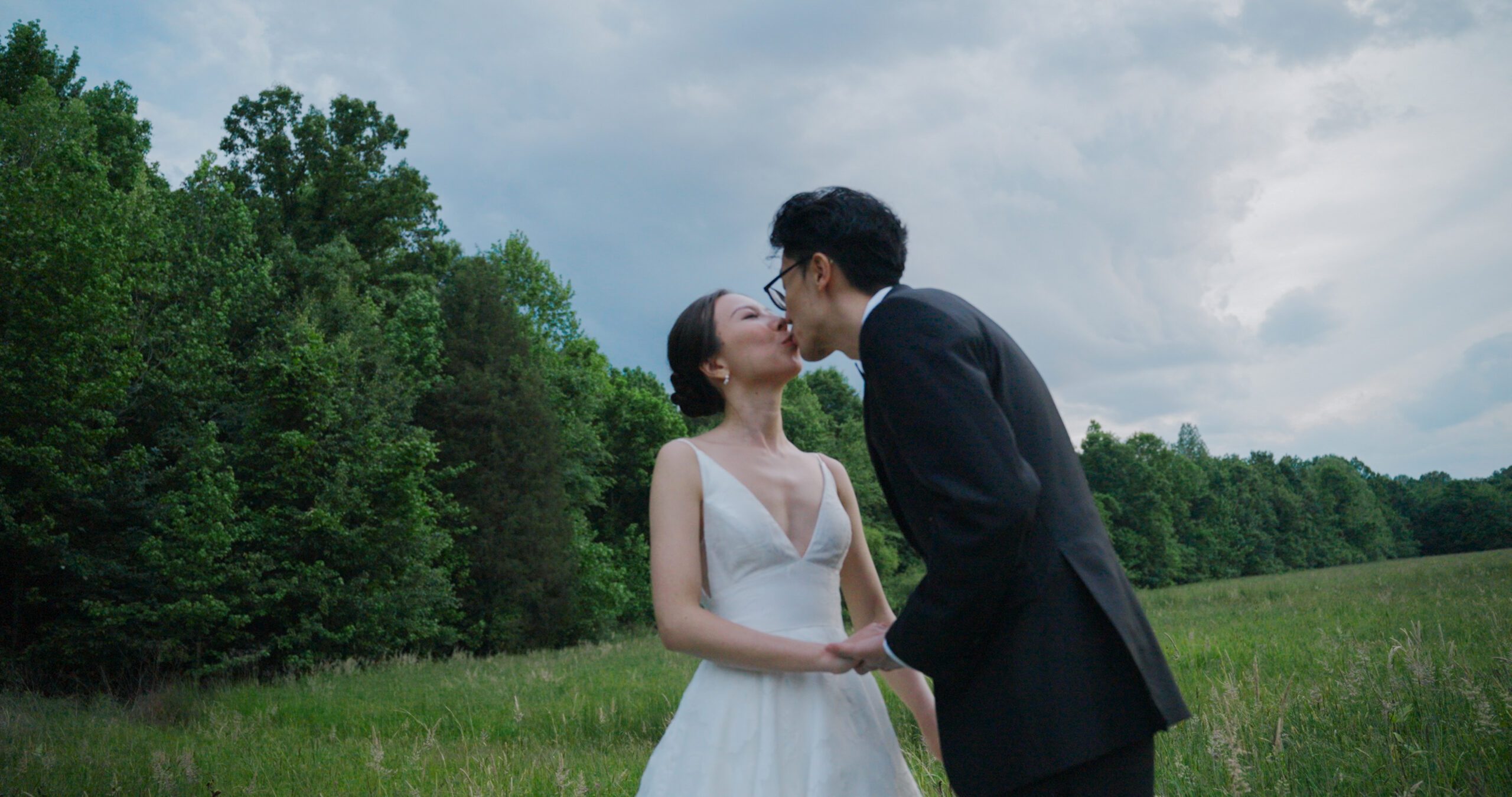 Christie and Hao share a kiss beneath the open sky at Haven Ridge.