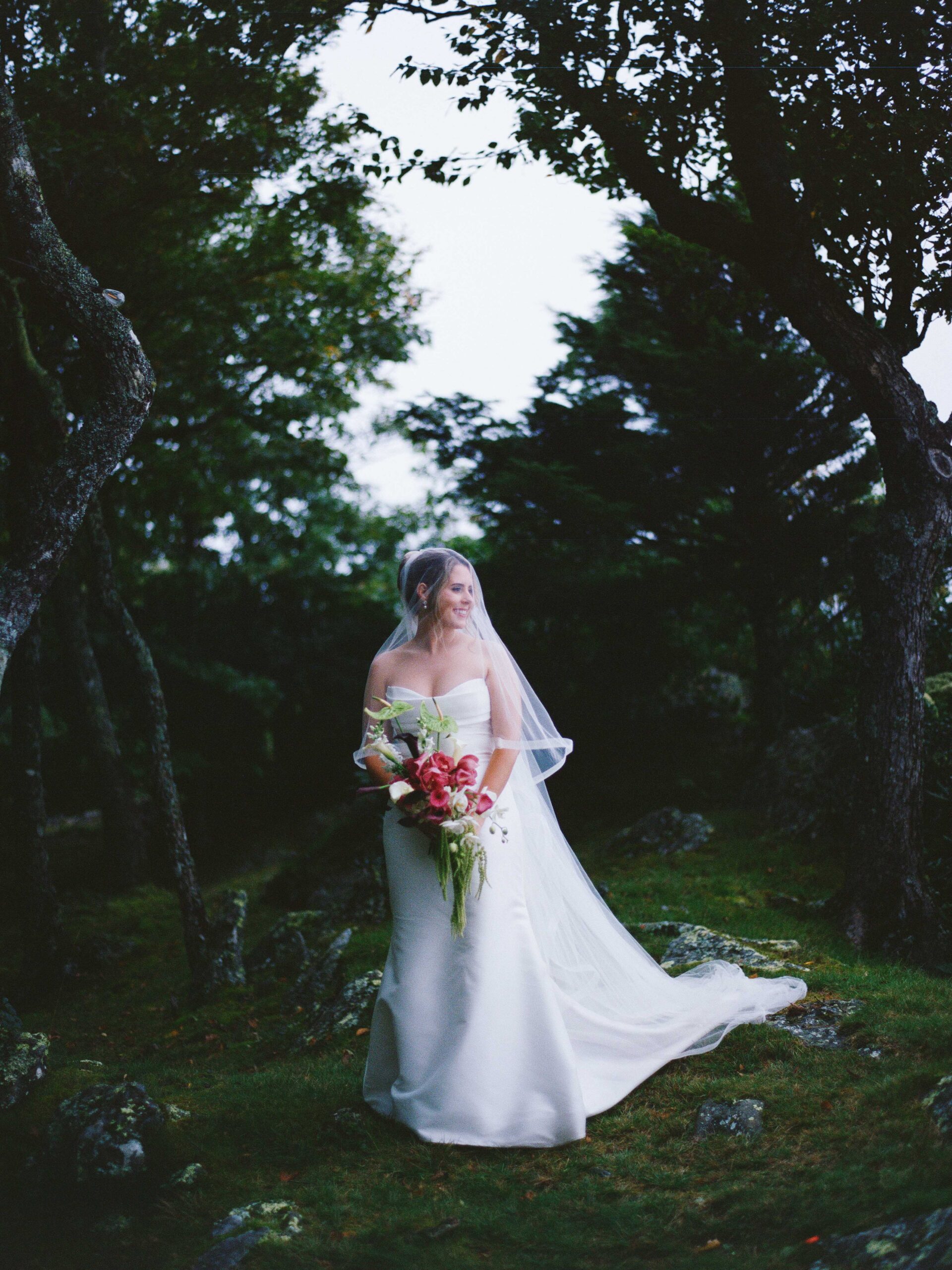 Bride holding a bouquet beneath trees at Twickenham House and Hall, photographed on medium format film