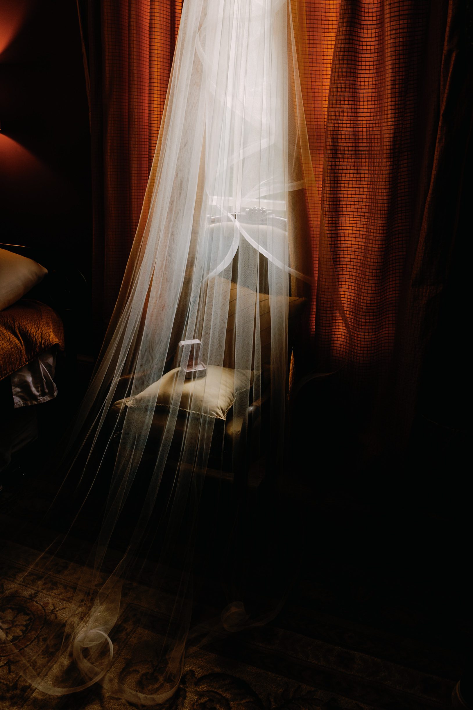 Wedding veil over a chair with an open ring box, photographed on medium format film at Twickenham House and Hall