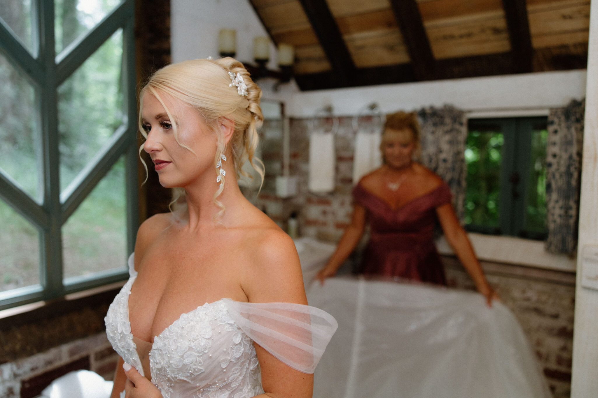 Bride getting ready into her wedding dress