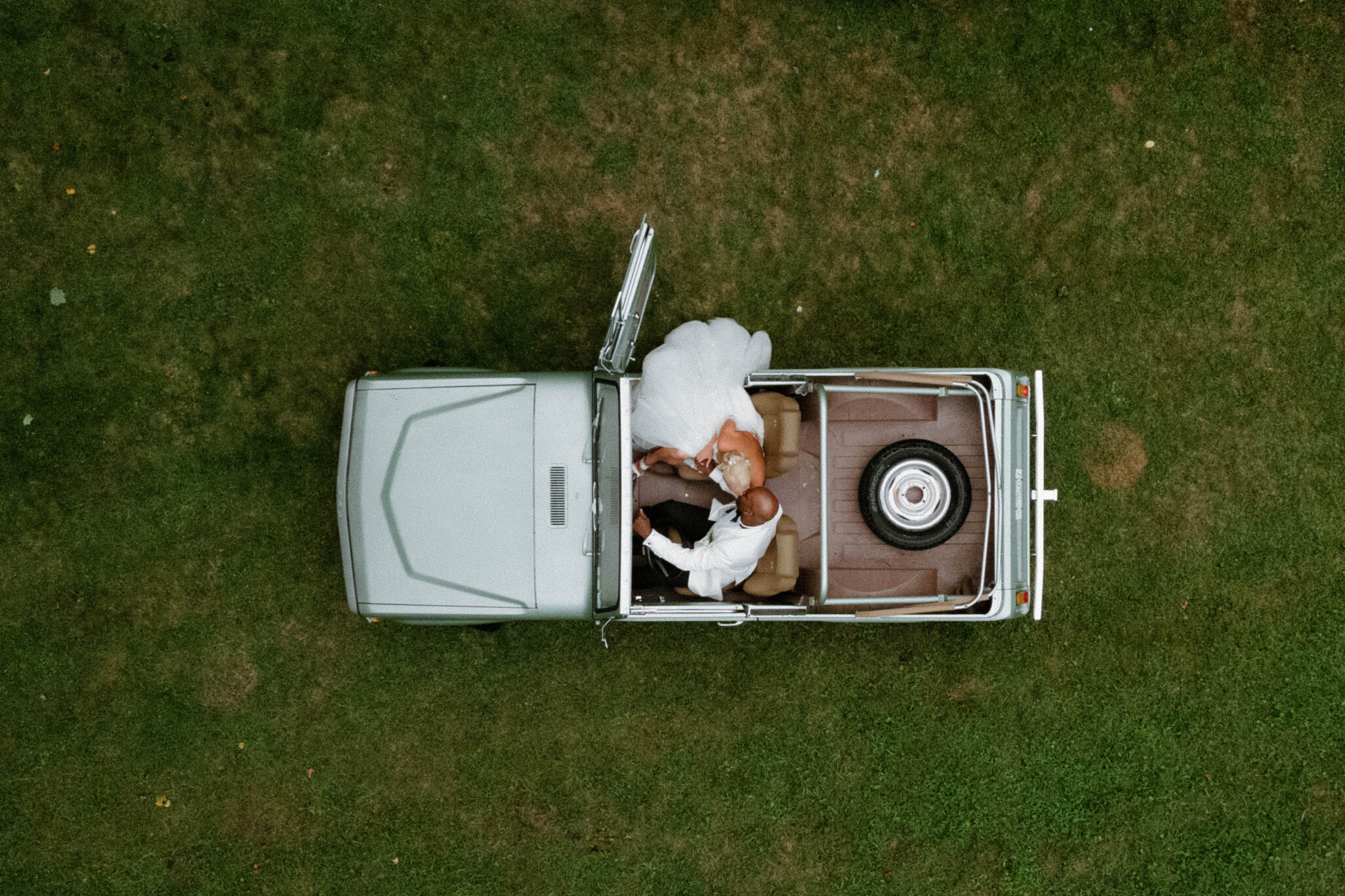 bride and groom in a classic car at Douglas Ellington House