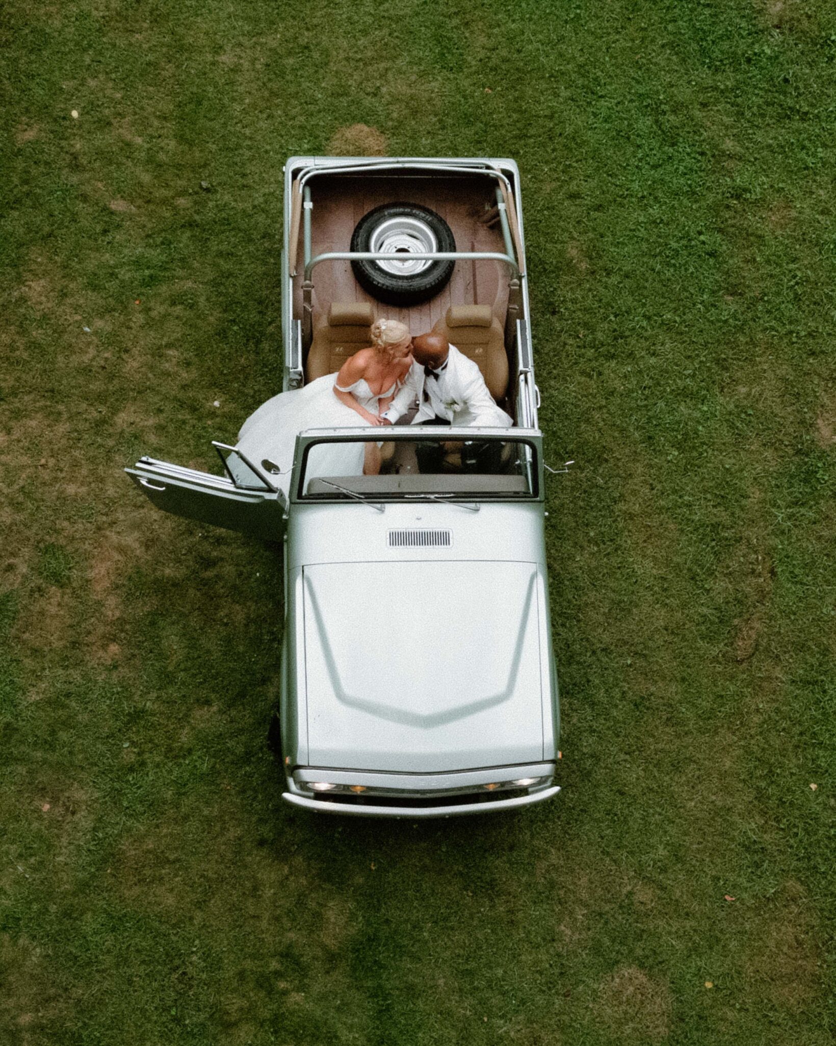 bride and groom in a classic car at Douglas Ellington House