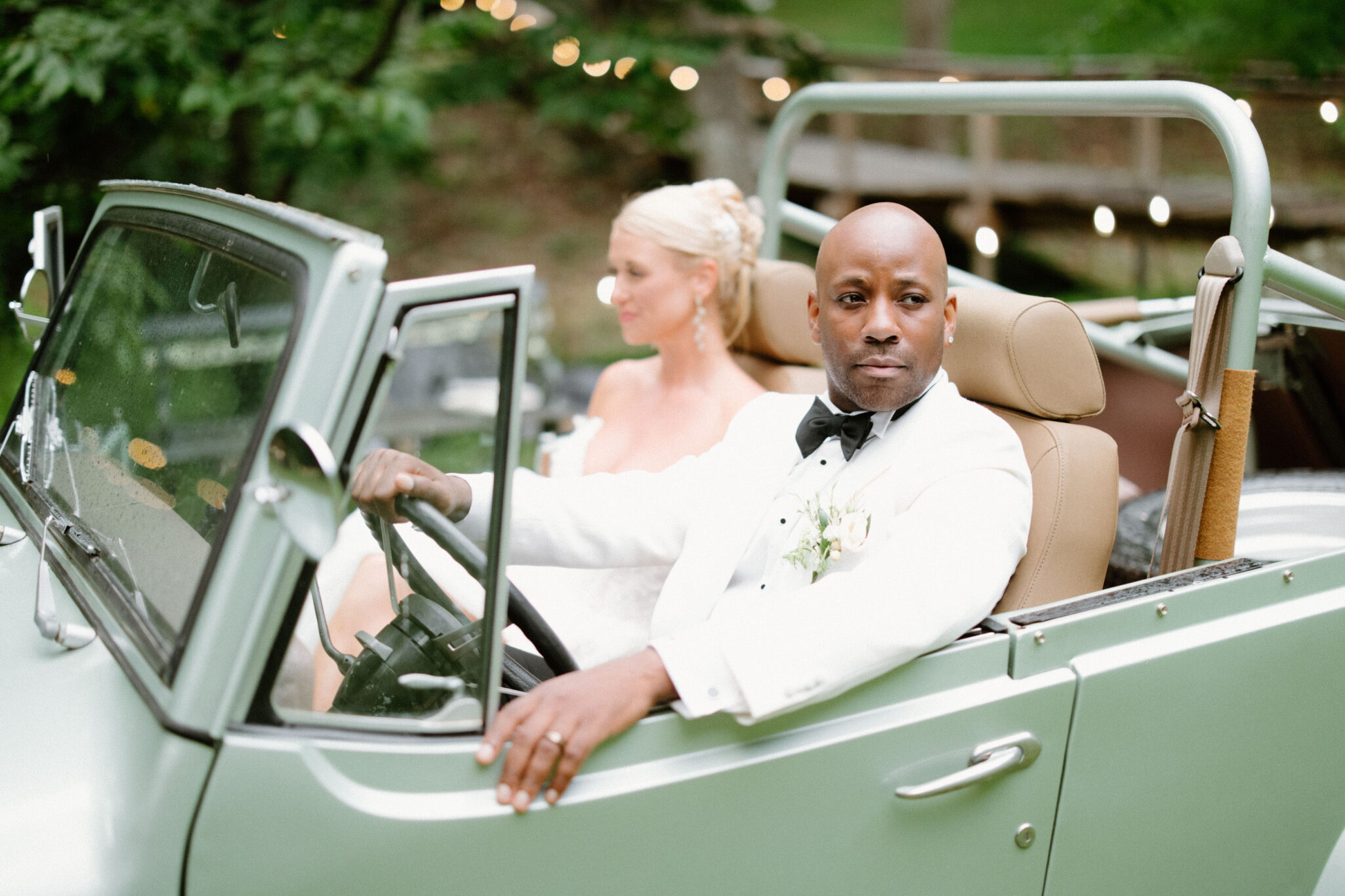 bride and groom in a classic car at Douglas Ellington House