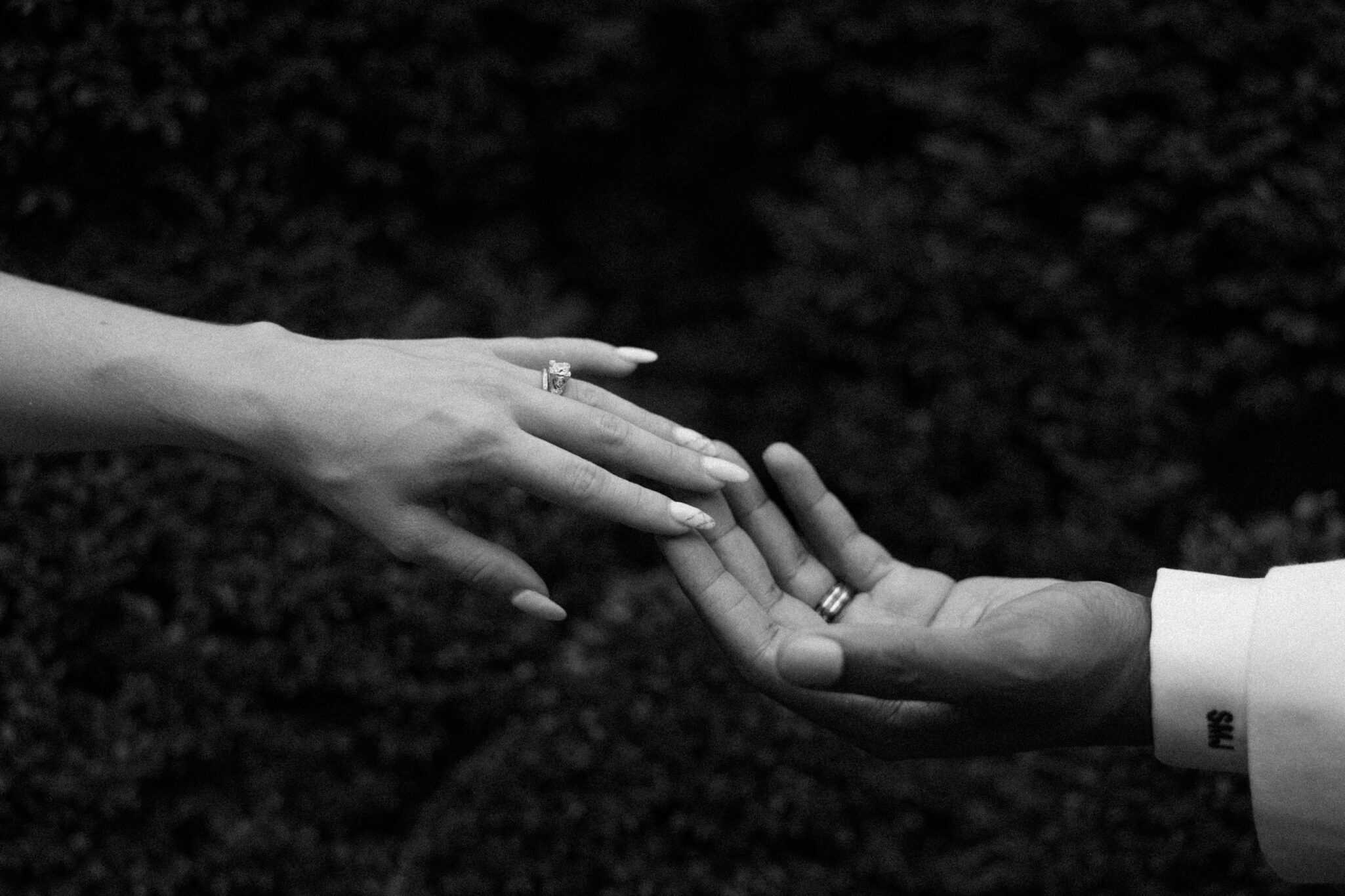 bride and grooms hands in black and white