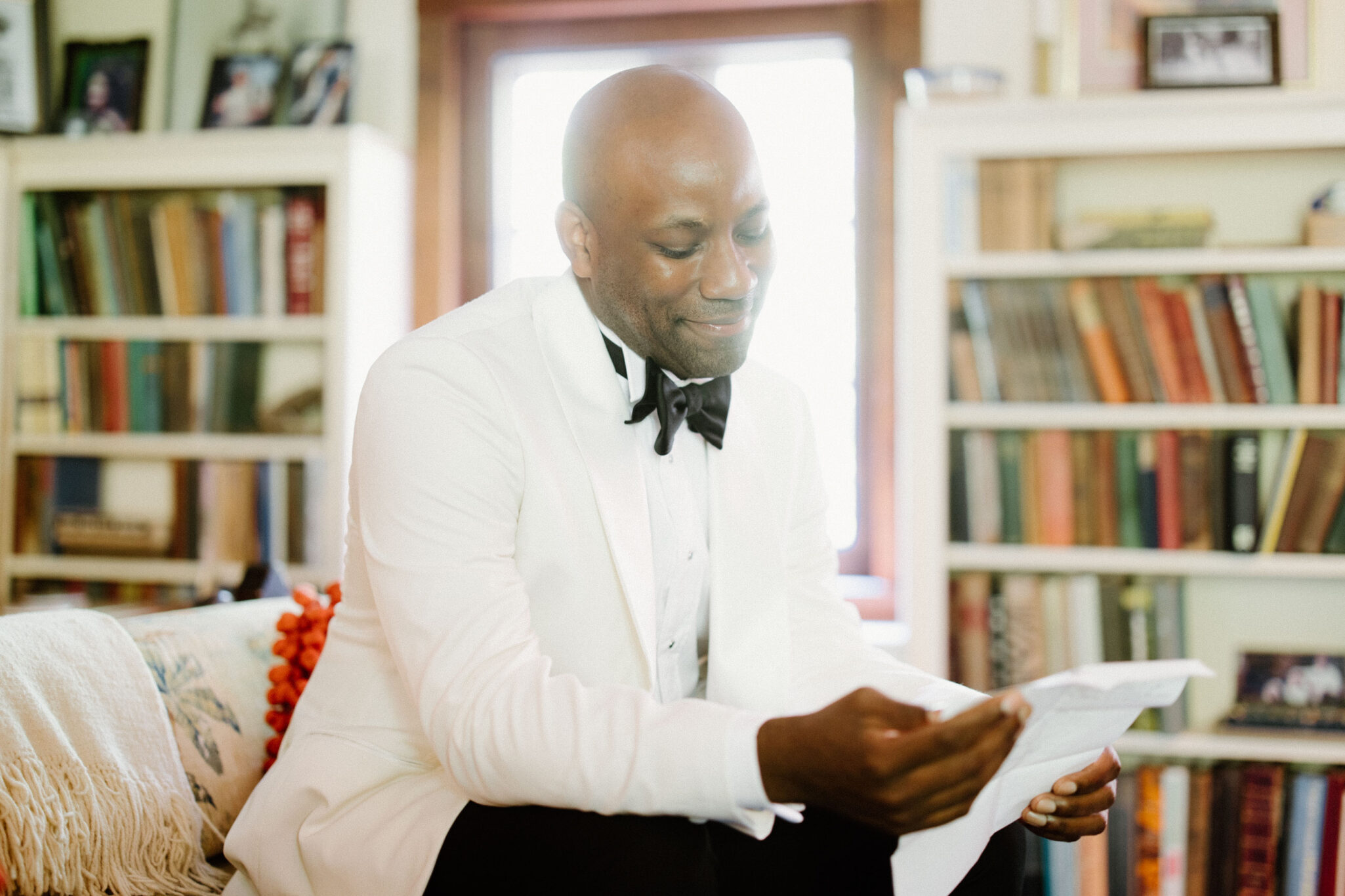 Groom reading letter inside before wedding ceremony