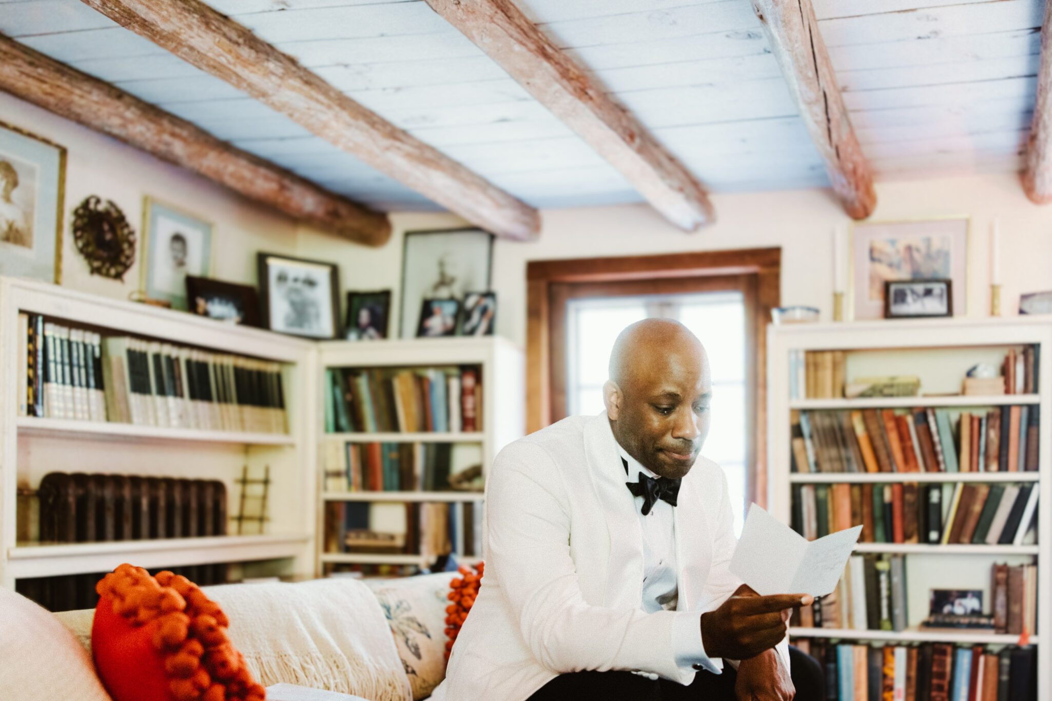 Groom reading letter inside before wedding ceremony