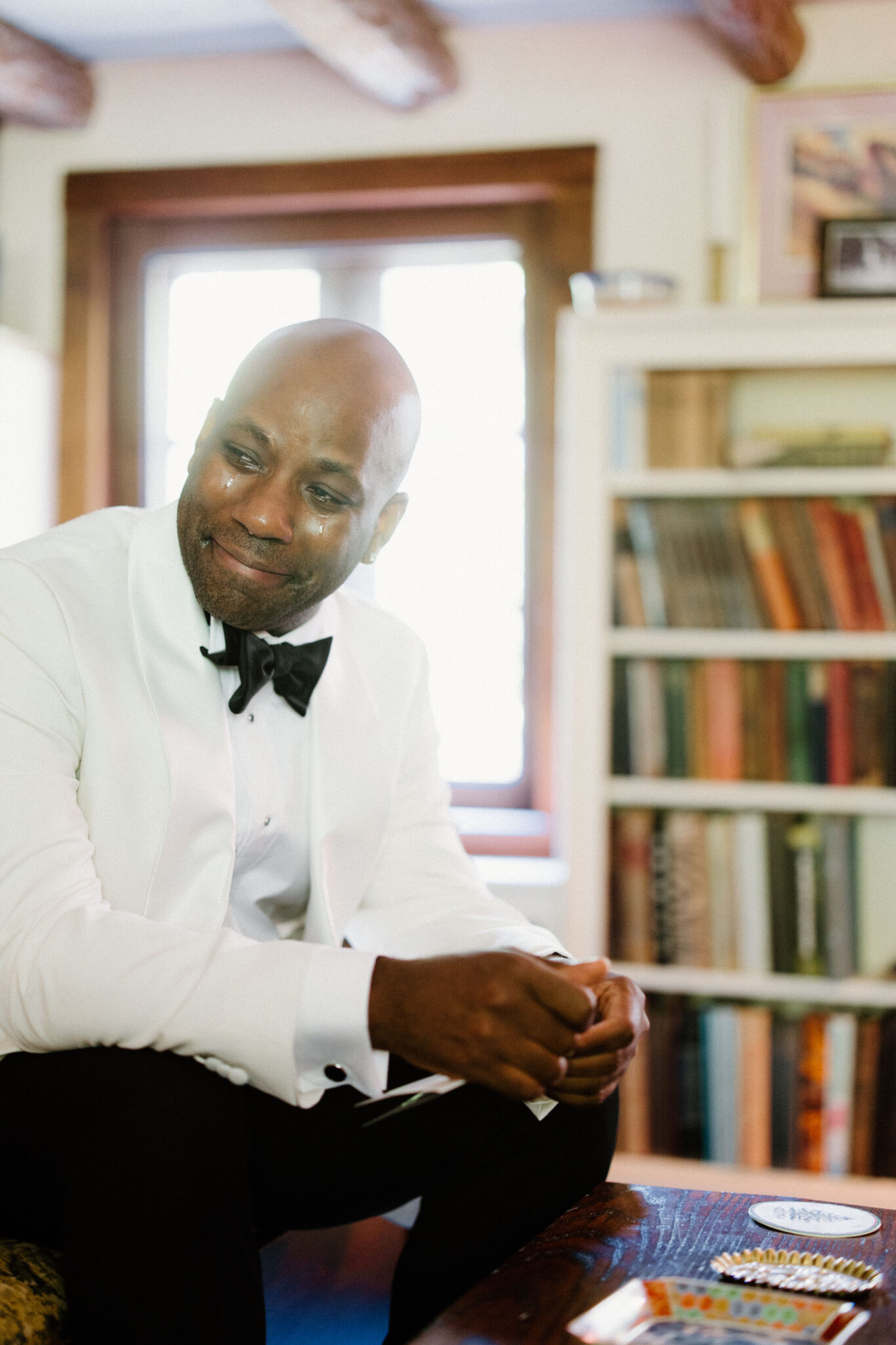 Groom reading letter inside before wedding ceremony