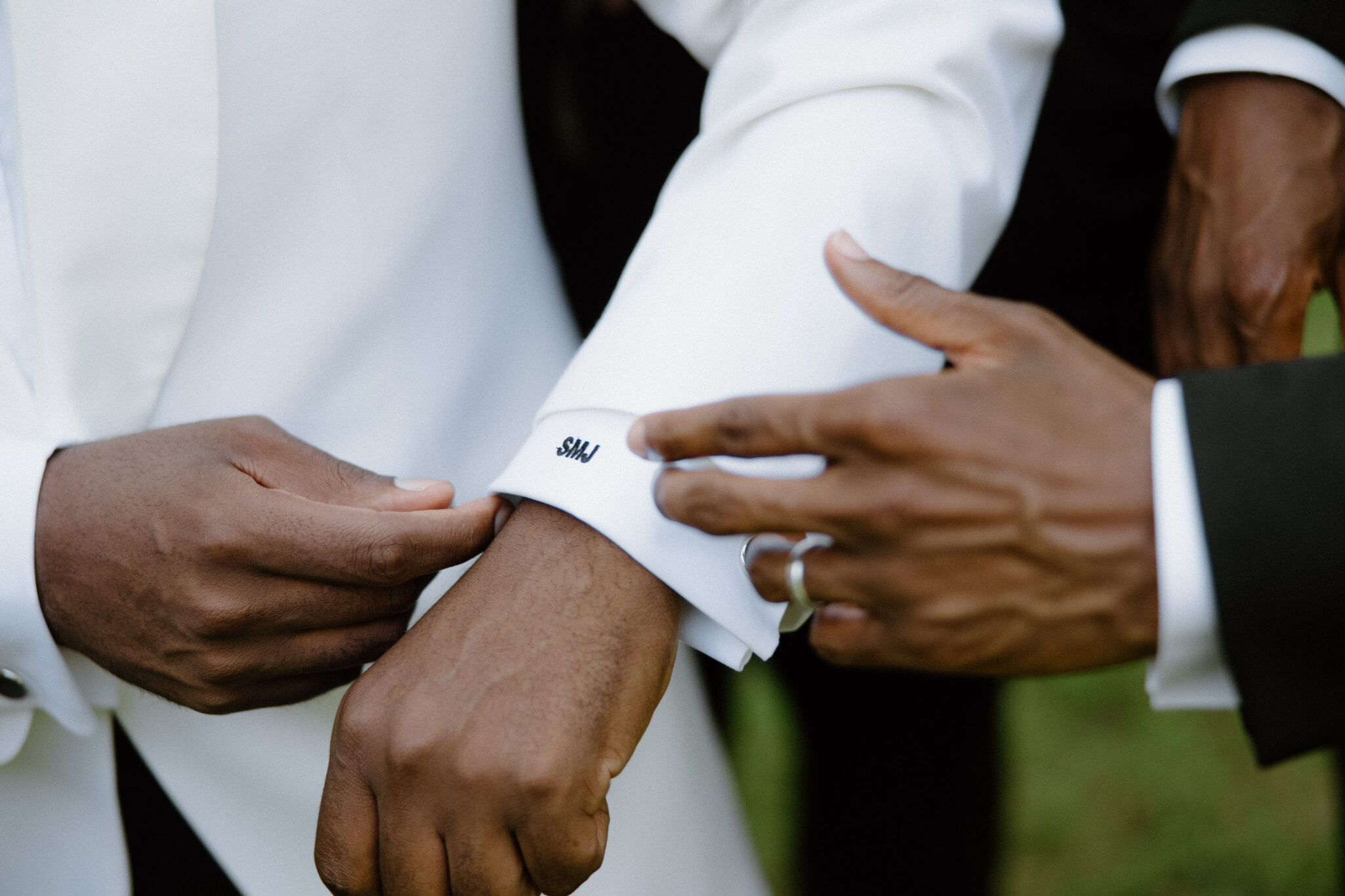 Groom and Groomsmen hanging out before wedding ceremony detail shot of initials