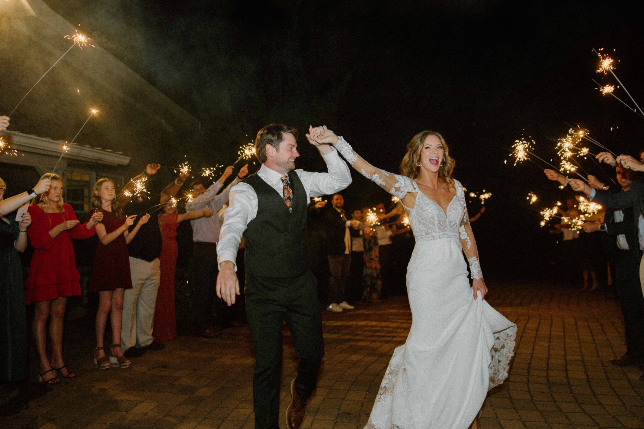 bride and groom exit their wedding at Chattooga Belle Farm under sparklers.