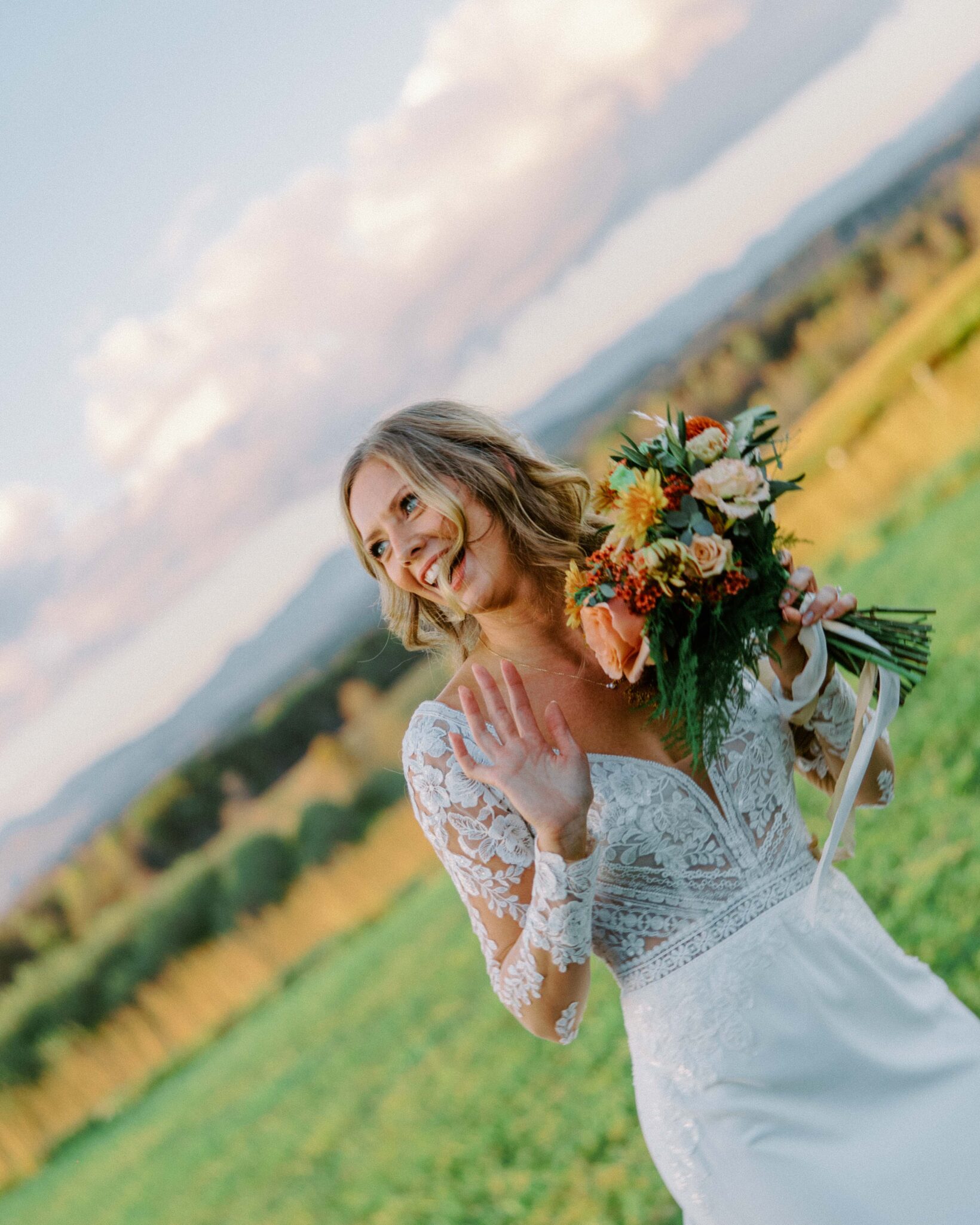 Bride laughs and celebrates after her ceremony in a field at Chattooga Belle Farm.