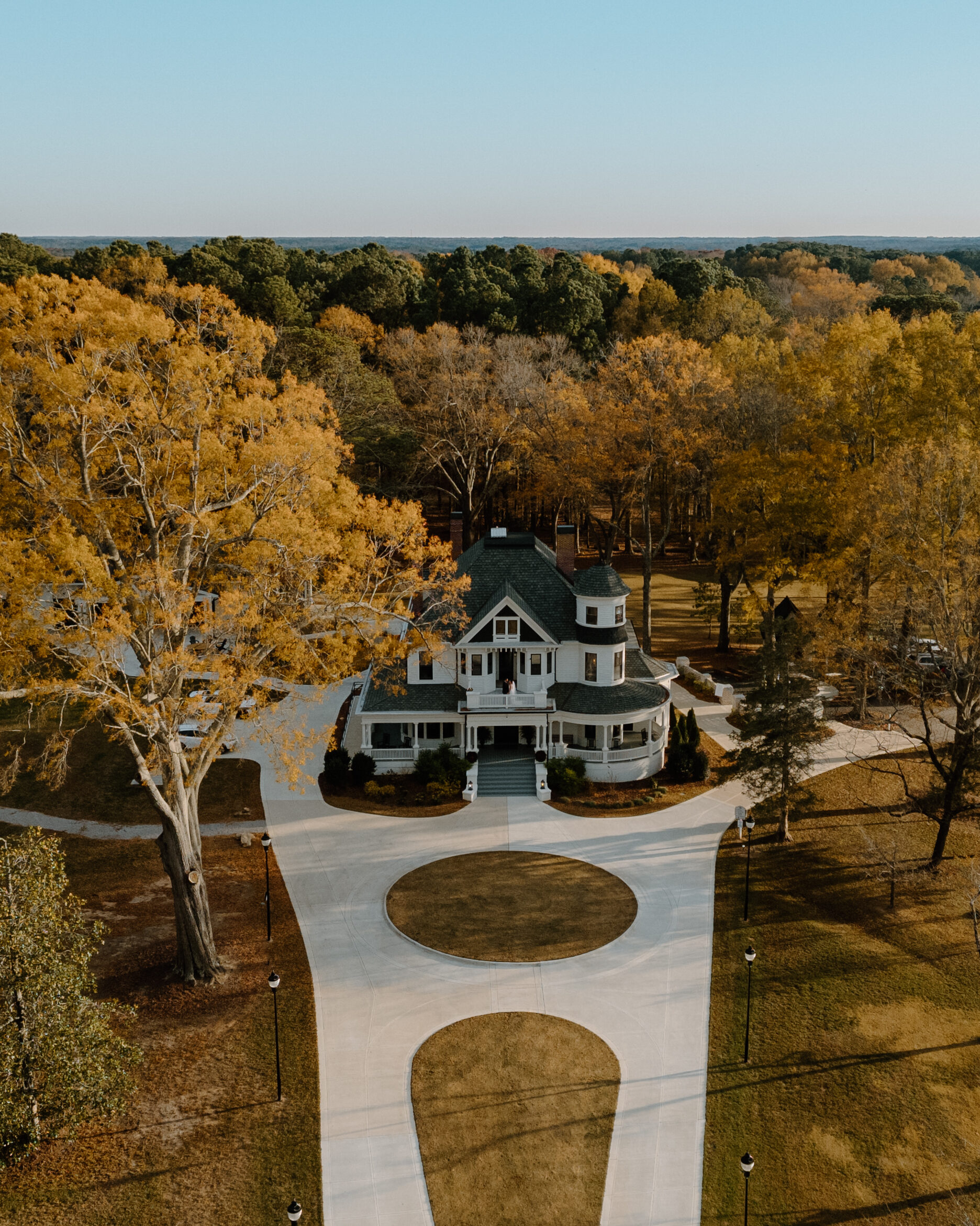 Exterior drone shot of historic wedding venue in North Carolina at the Carolina Manor House in fall.