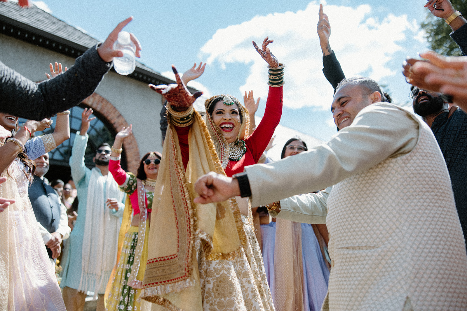 An indian bride dances with her family outside her wedding at The Biltmore Estate