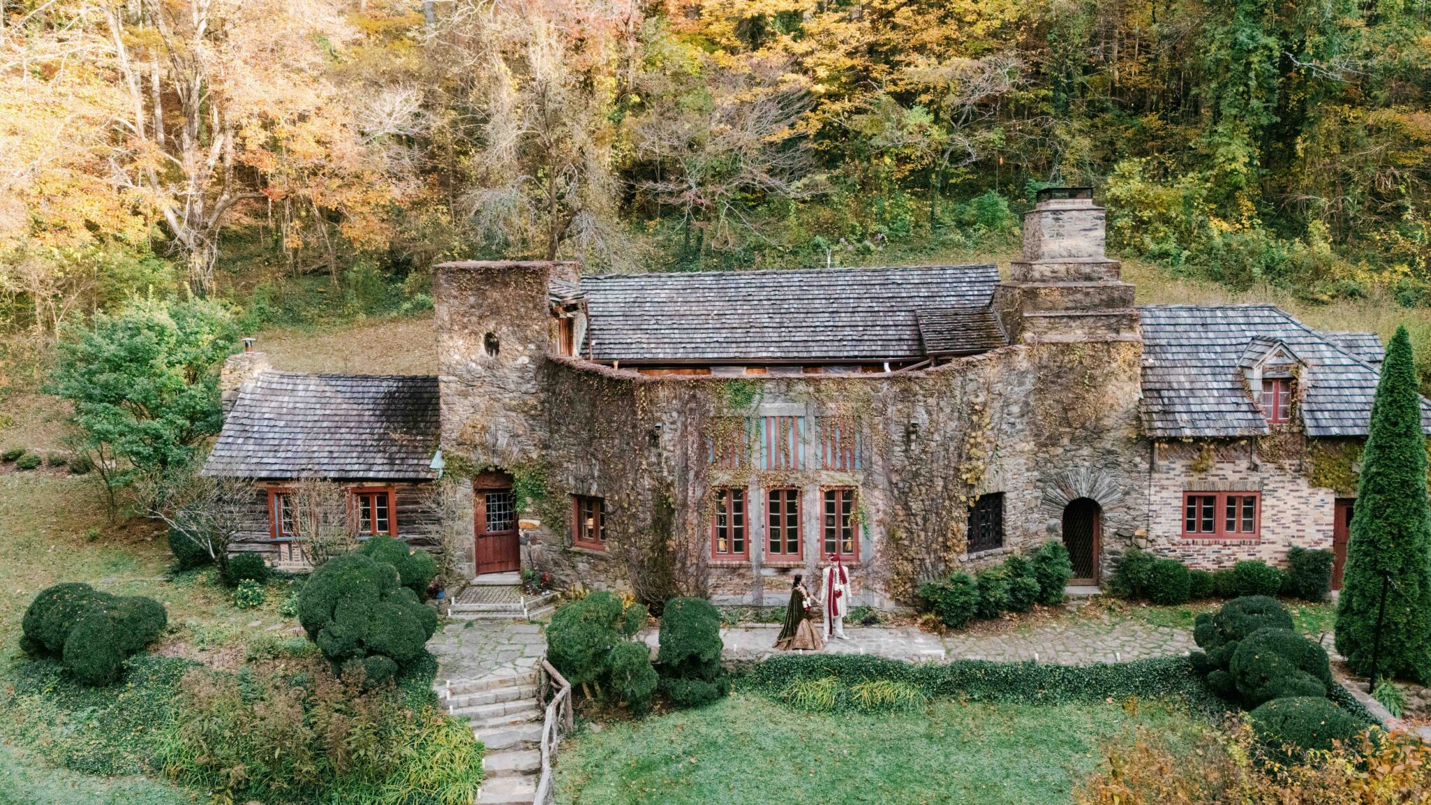 Cinematic couple’s portrait surrounded by spring color at an Asheville Indian wedding, captured by drone. 
